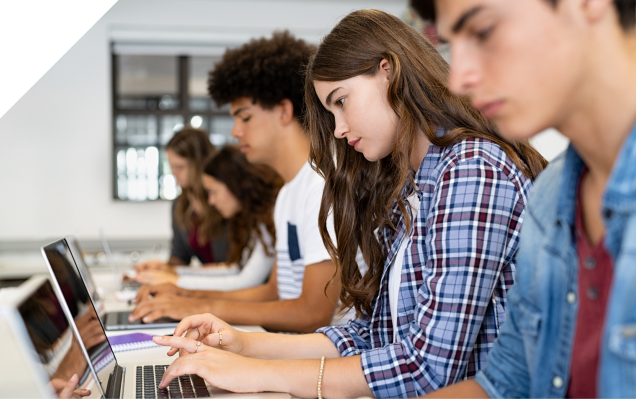 Students working on laptops in a classroom